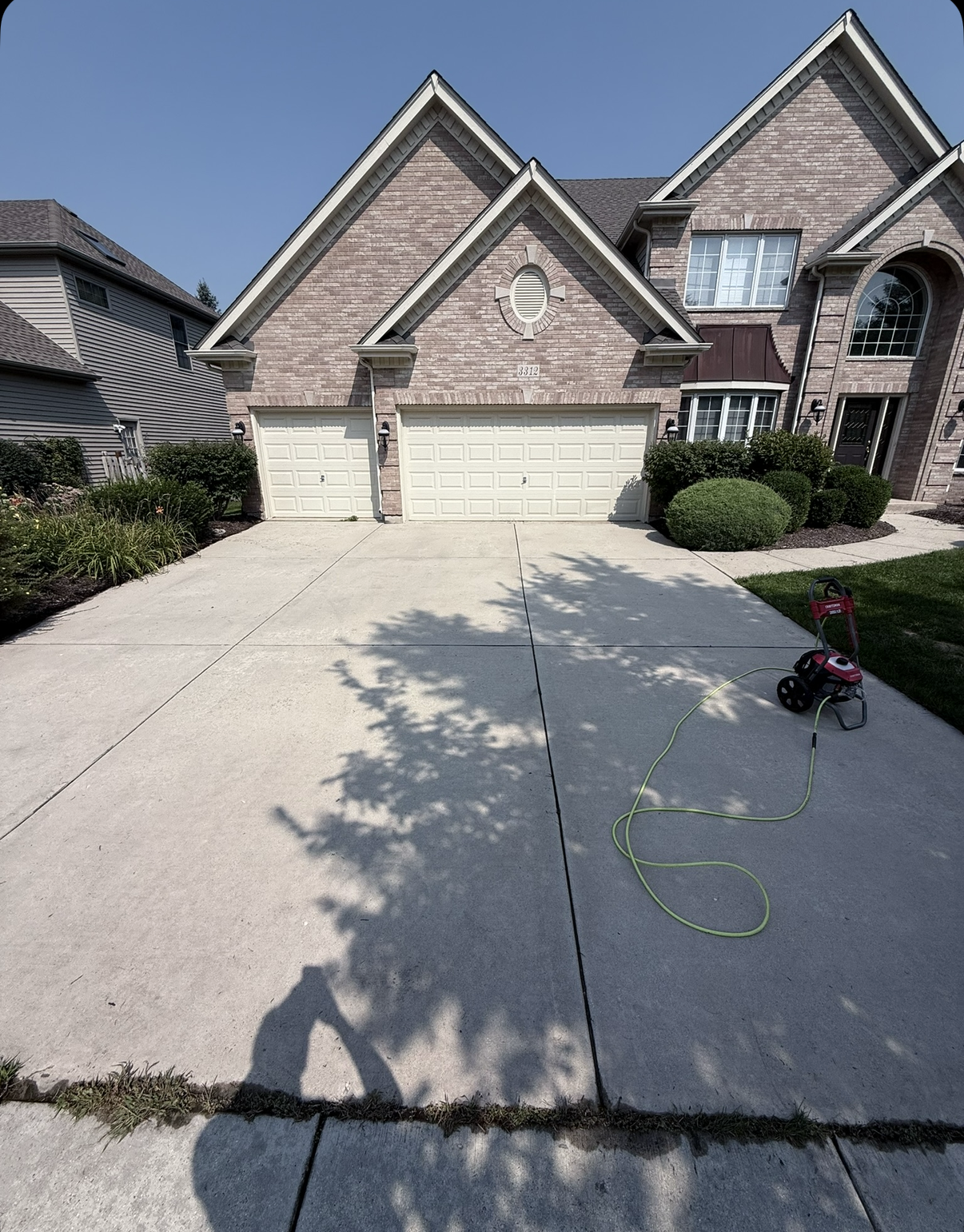 Clean concrete driveway after pressure washing